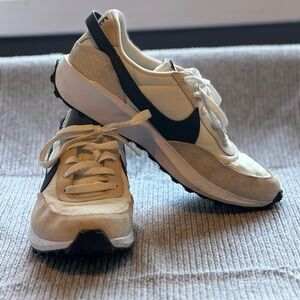 Women’s Nike waffle one trainers in cream and black.